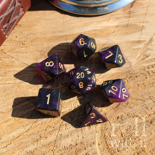 Purple star like glitter polyhedral dice set on a wooden surface