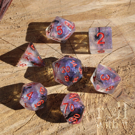 Set of 7 purple dark goth aesthetic polyhedral D&D dice with red numbers on a wooden surface