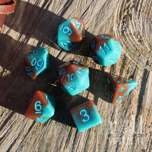 Set of polyhedral dice with blue and brown colors and blue numbers on a wooden surface