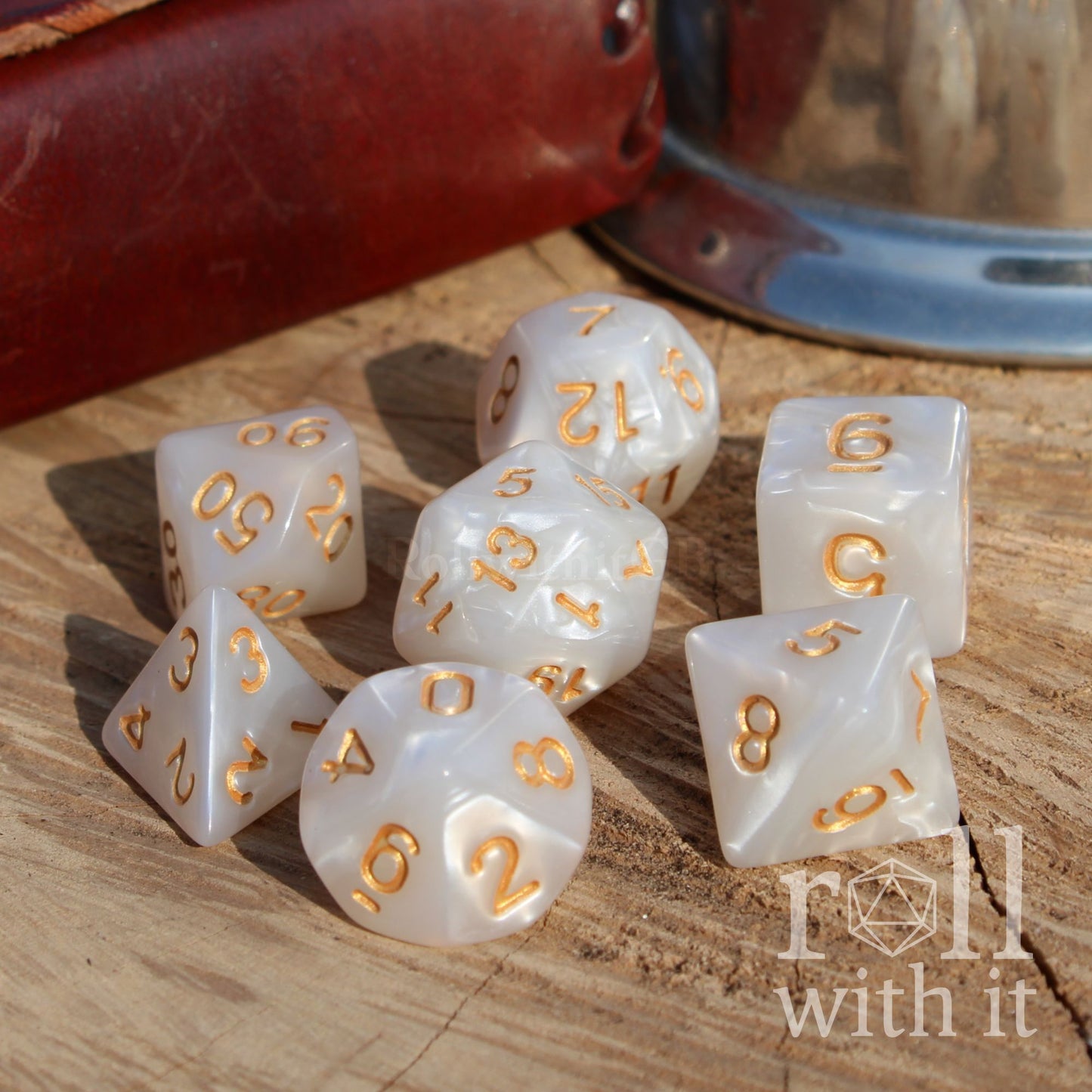 Side view of 7 dnd paladin themed polyhedral dice