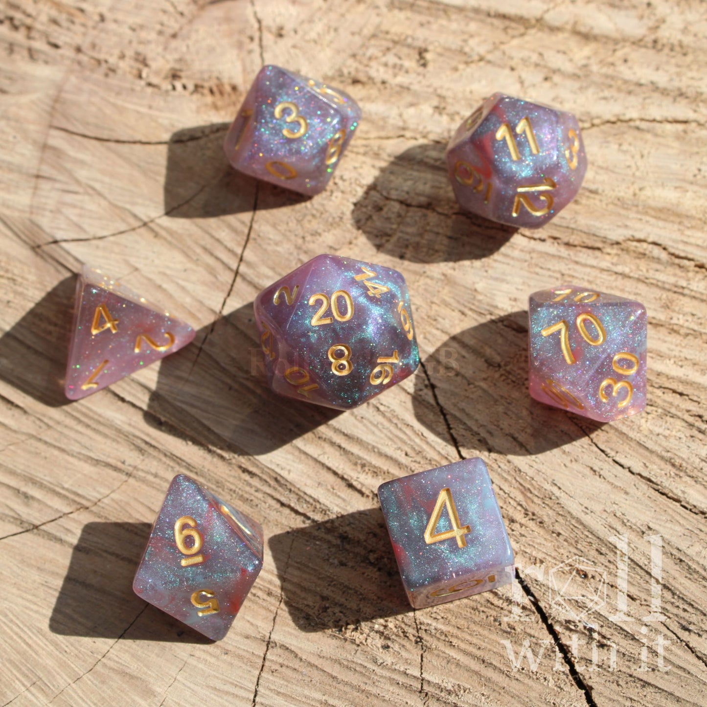 Set of colorful easy to read space purple stars polyhedral dice on a wooden surface