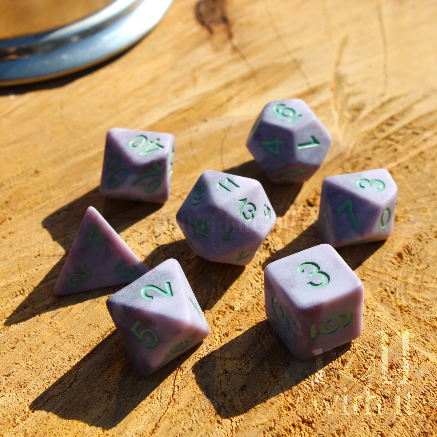 Purple pale matte cute lilac DND polyhedral dice on a wooden surface