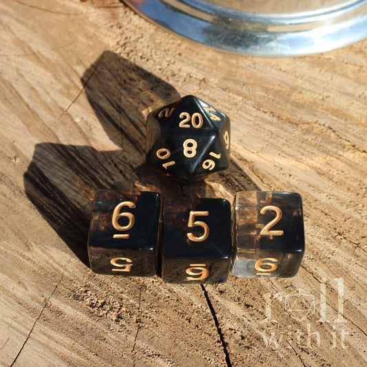 Black swirl DnD dice with gold numbers on a wooden surface