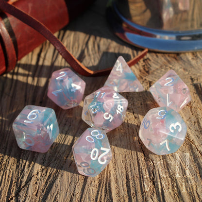 7 Pink blue pale resin roleplaying gamers gift dice with white numbers on a wooden surface