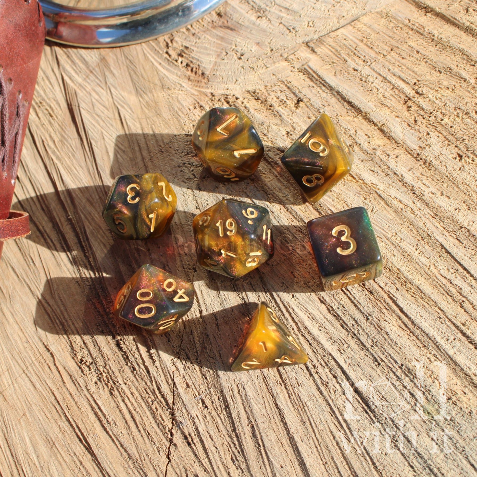 Set of amber-colored polyhedral dice on a wooden surface