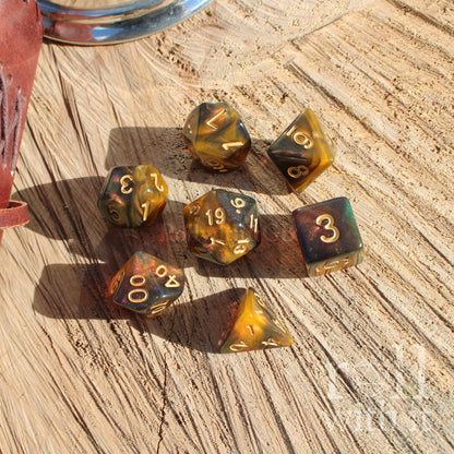 Set of amber-colored polyhedral dice on a wooden surface