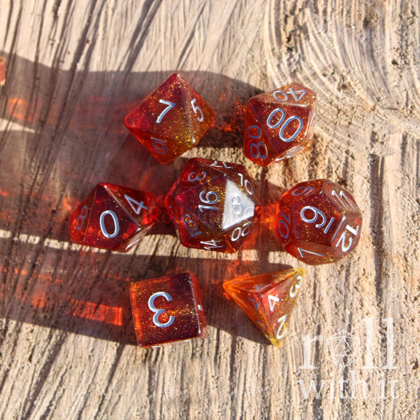 Glowing red glitter orange sun like DND dice set on a wooden background