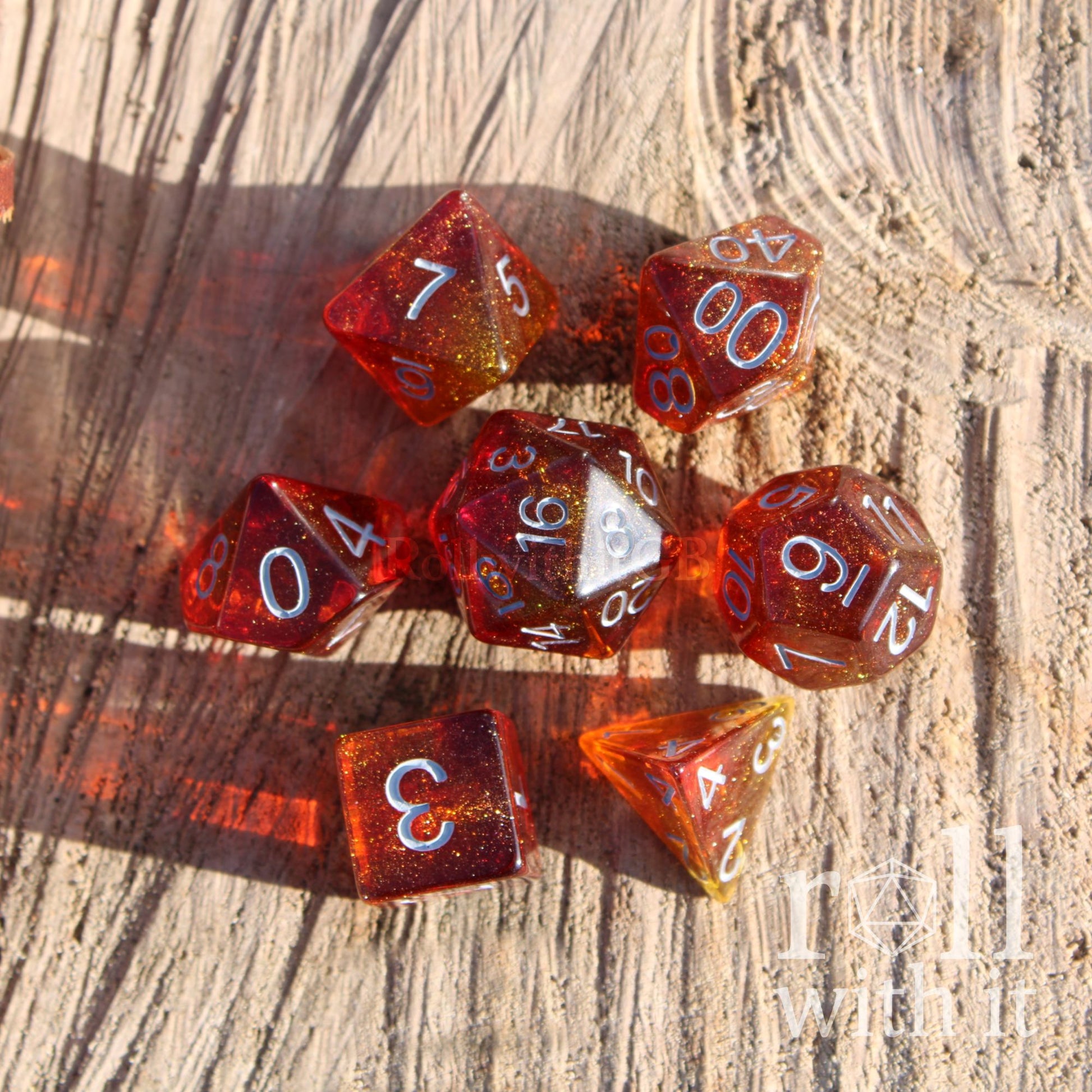 Glowing red glitter orange sun like DND dice set on a wooden background