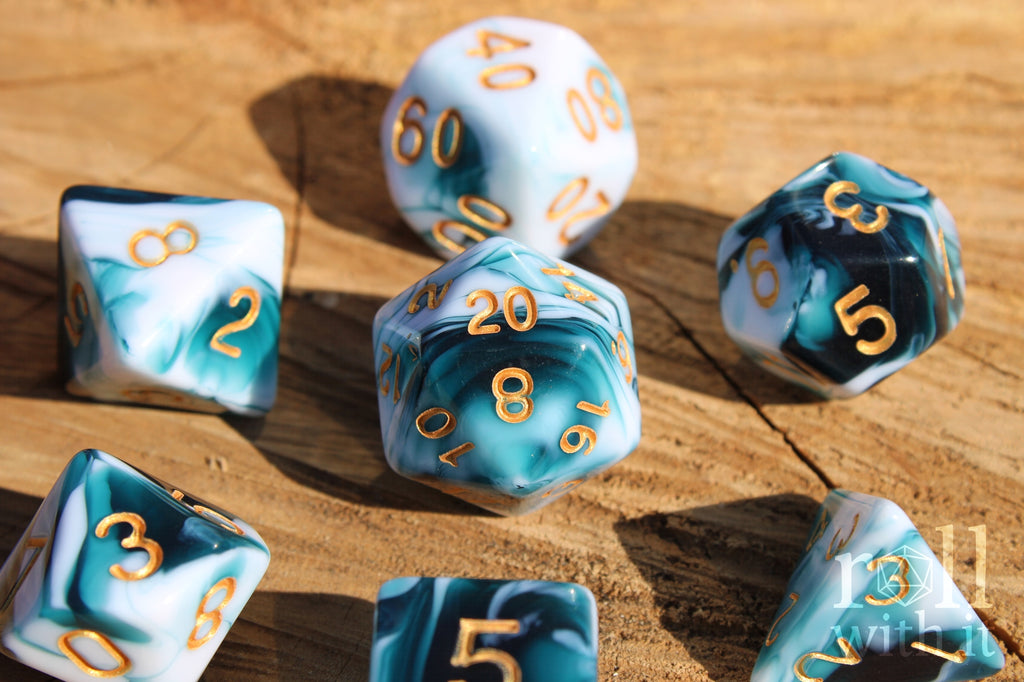 Set of polyhedral roleplaying dice with blue and white marbling on a wooden surface