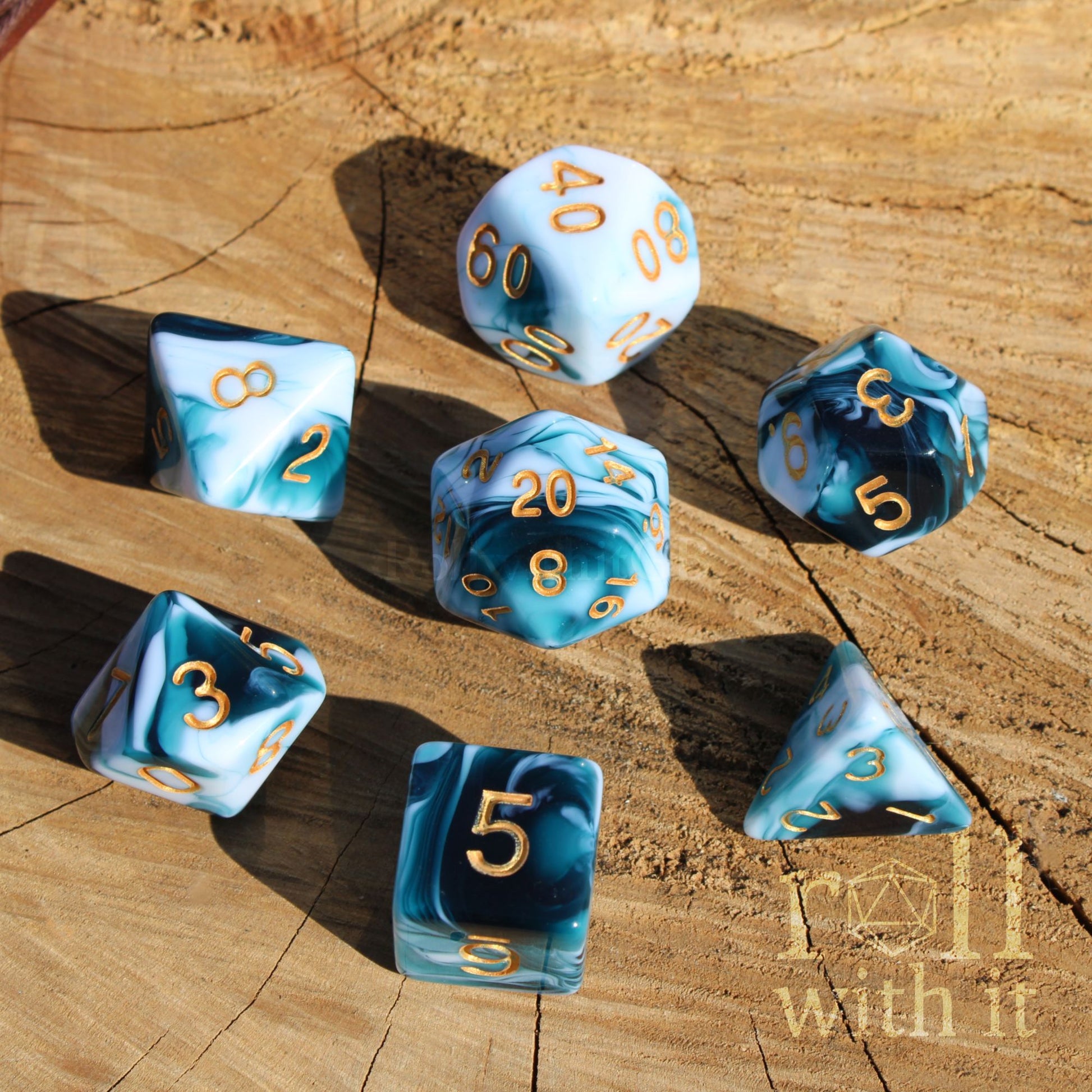 Set of white and blue swirling roleplaying dice with gold numbers on a wooden surface