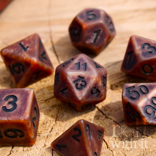 Bronze brown matte dungeons and dragons dice on a wooden surface