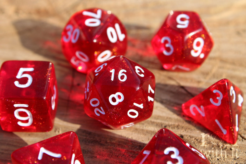 Scarlet red glittery polyhedral roleplaying dice with white numbers on a surface