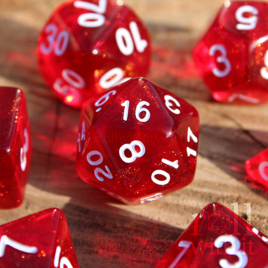 Scarlet red glittery polyhedral roleplaying dice with white numbers on a surface