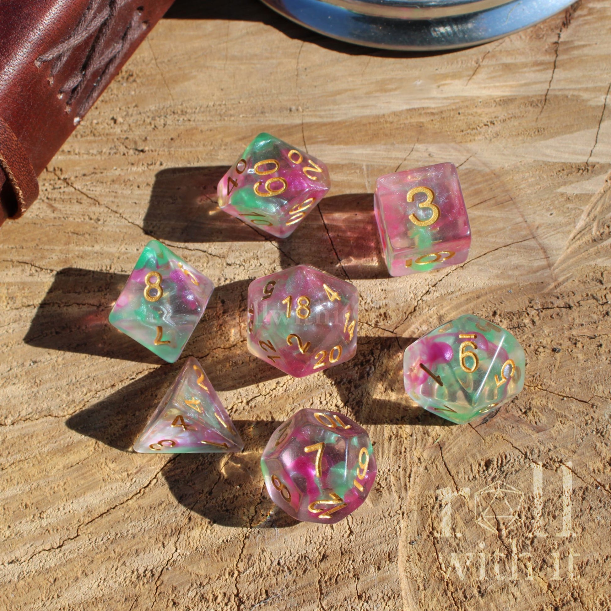 Set of colorful purple green dungeons and dragons polyhedral dice on a wooden surface