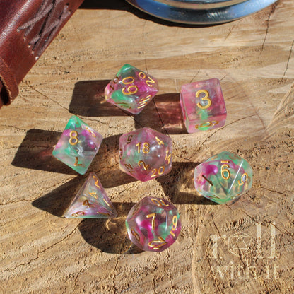Set of colorful purple green dungeons and dragons polyhedral dice on a wooden surface