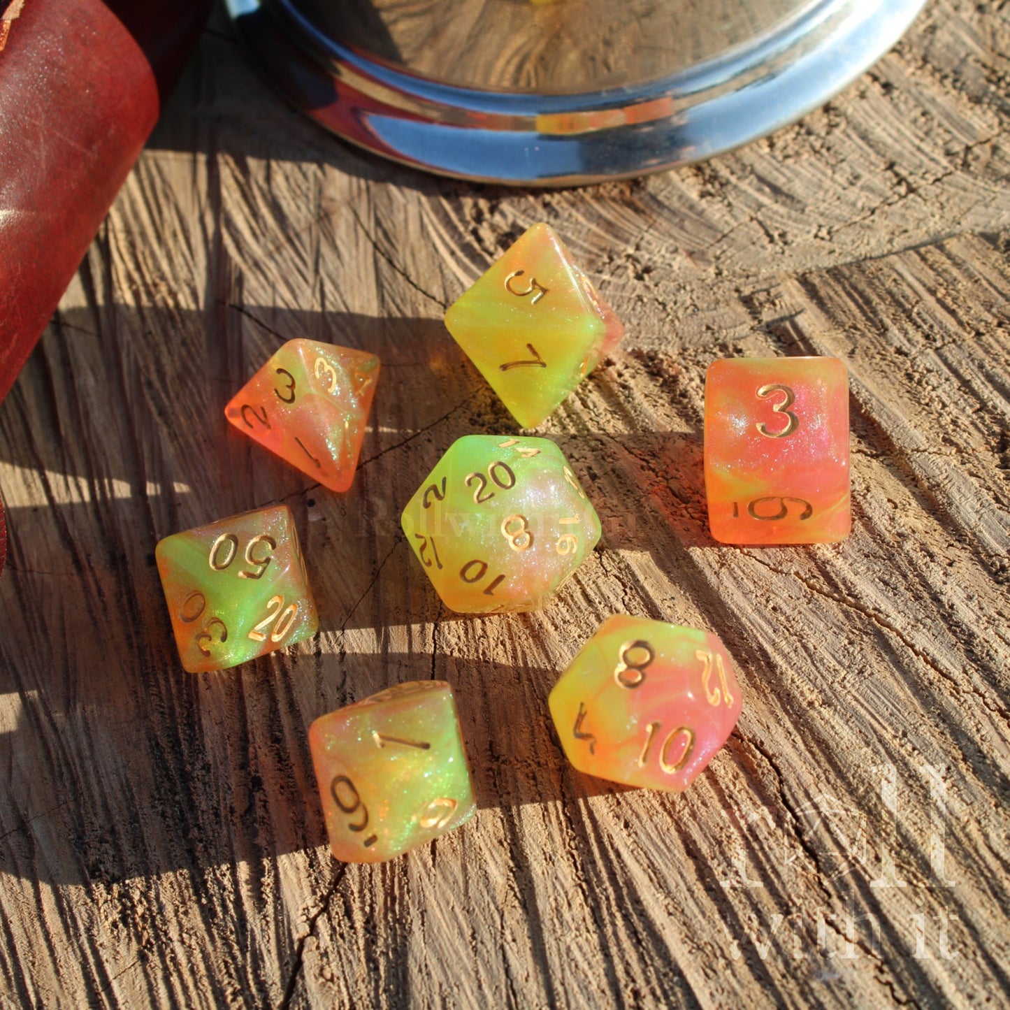 Set of shining colorful peachy green spring glitter golden numbered dnd dice on a wooden surface