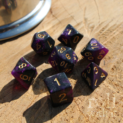 Purple polyhedral dice set on a wooden surface