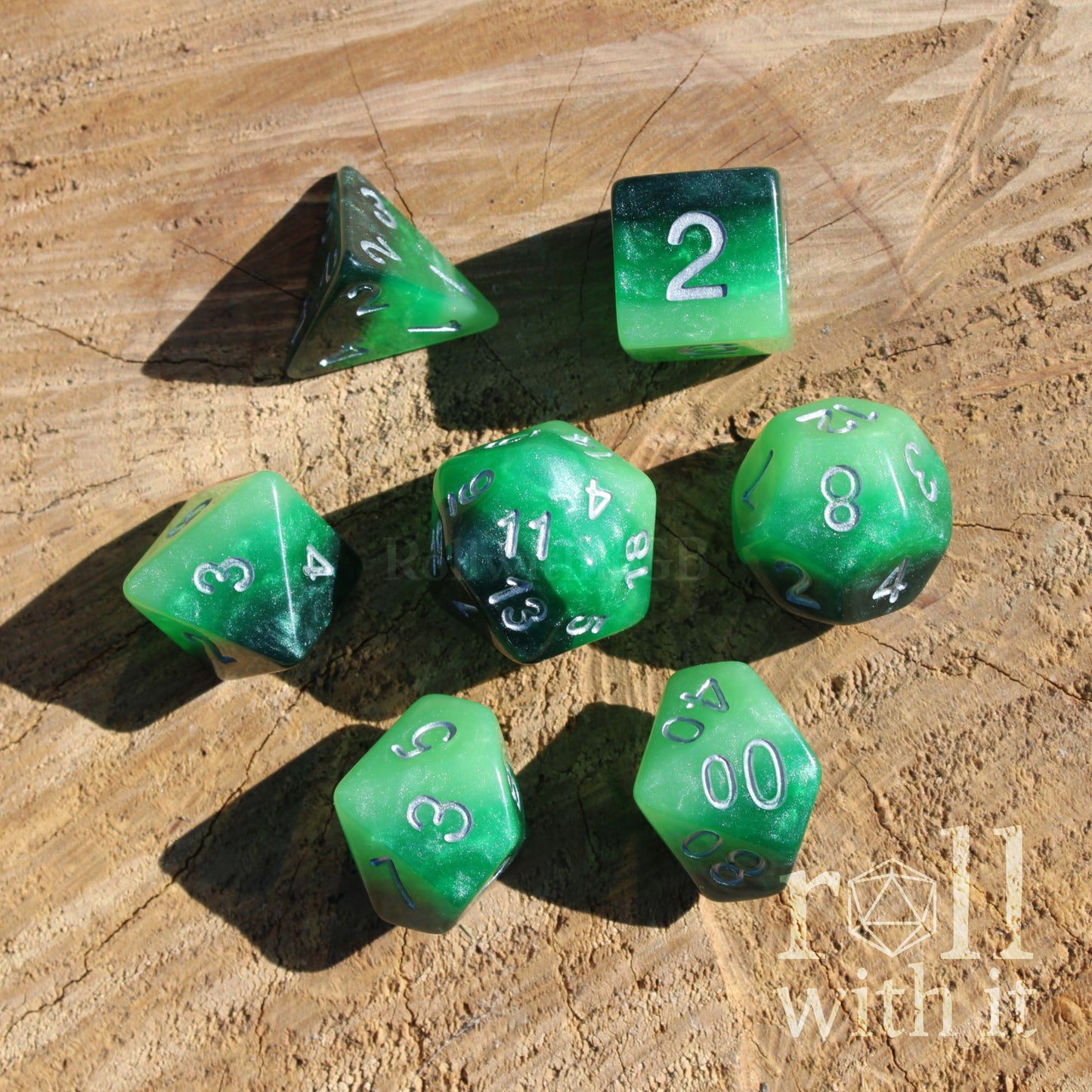 Set of 7 green eldritch warlock aesthetic polyhedral dice on a wooden surface with 'roll with it' branding.