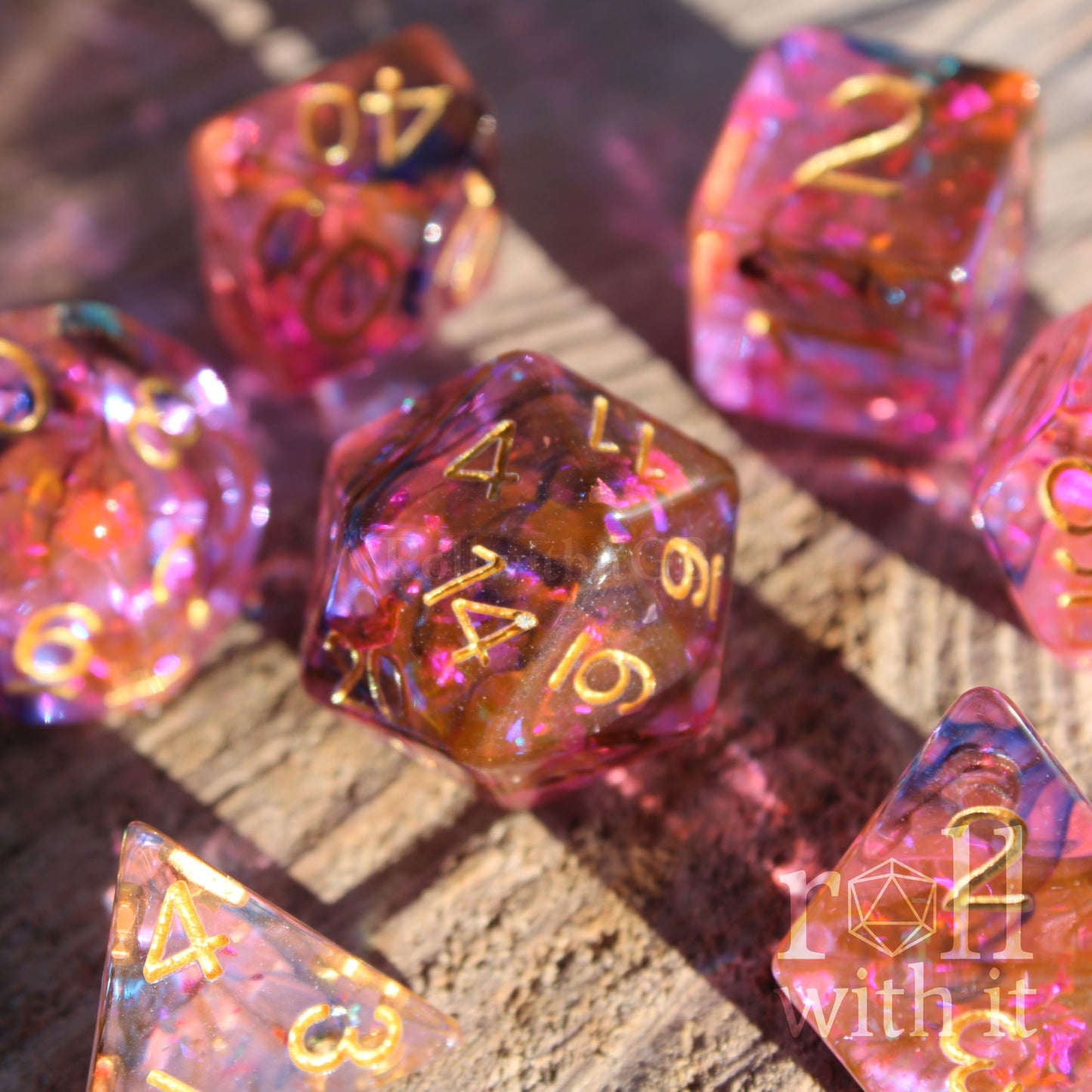 Set of colourful purple and swirling black and orange polyhedral dice on a wooden surface
