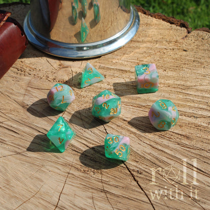 Set of colorful teal bluepolyhedral dice on a wooden surface.