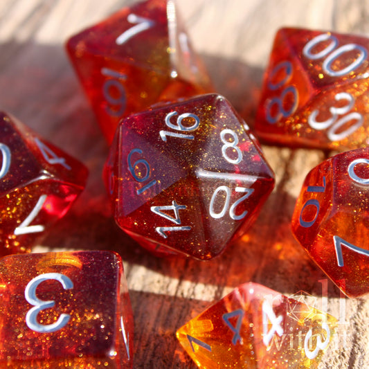 Set of vibrant and glittery red and orange polyhedral roleplaying dice with white numbers on a wooden surface