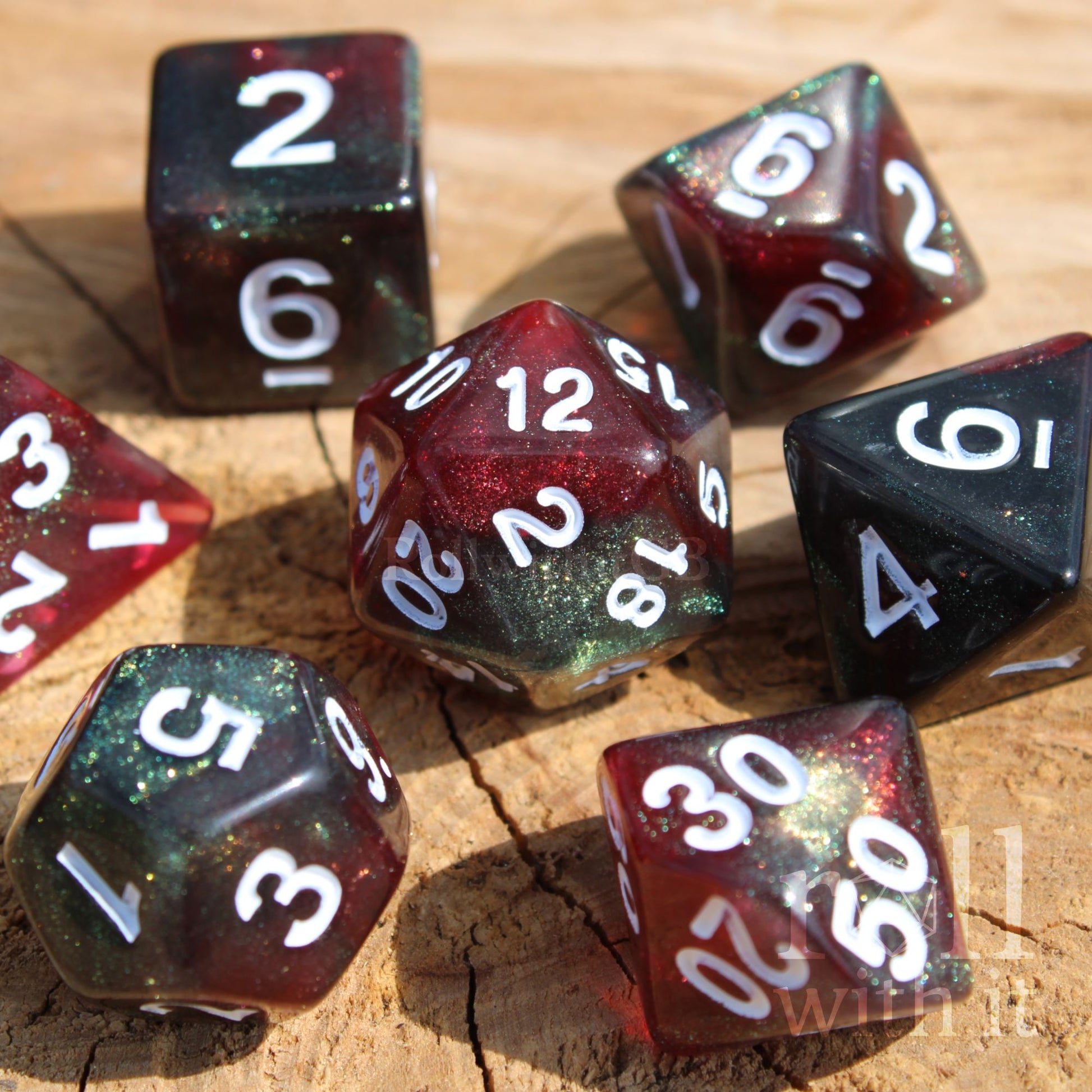 Set of glittery and star like black and red polyhedral dice with a green shimmer on a wooden surface