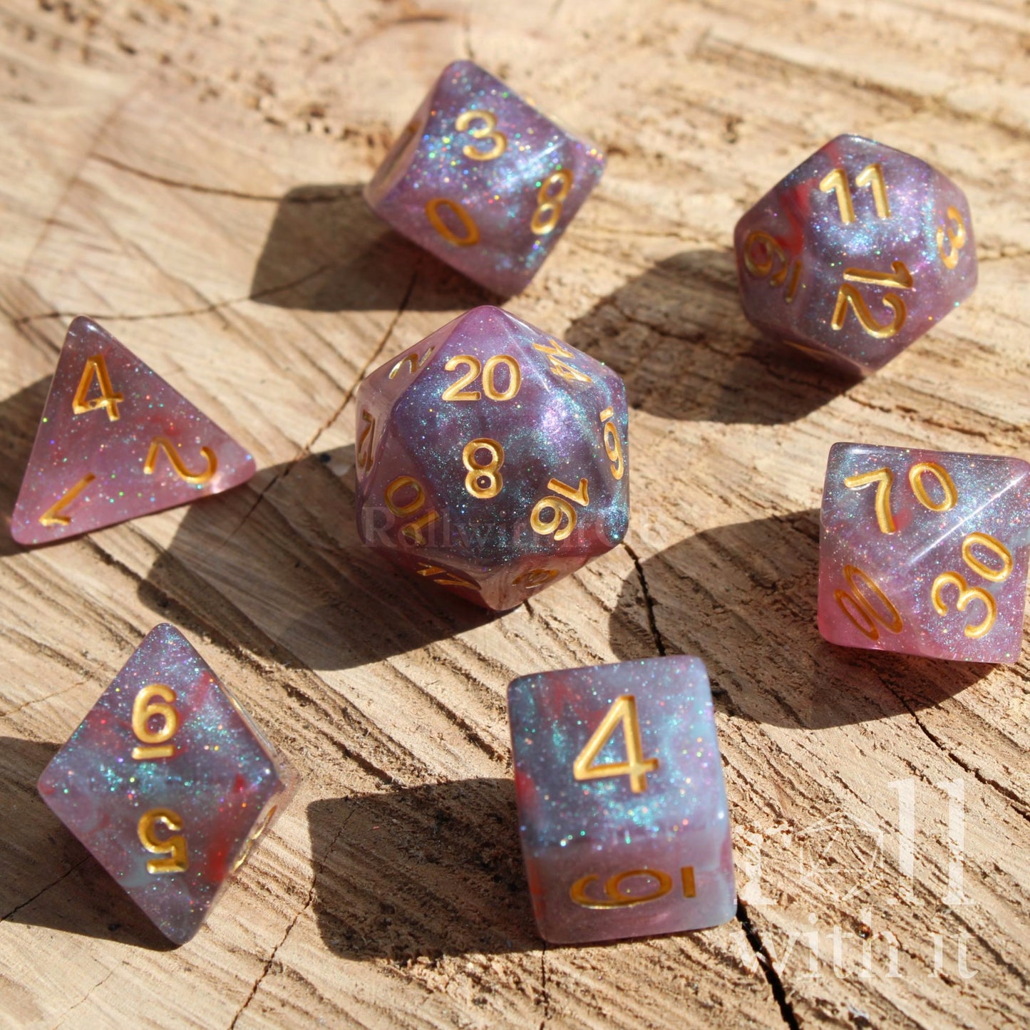 Set of glittery star like purple and blue polyhedral dice on a wooden surface
