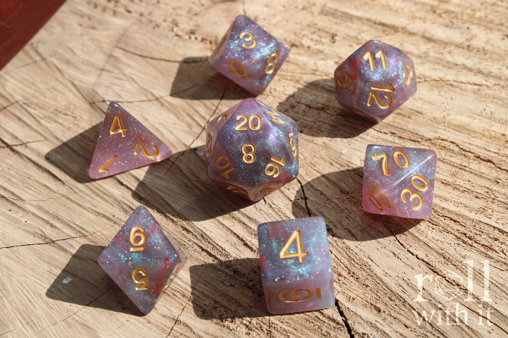 Set of glittery star like purple and blue polyhedral dice on a wooden surface