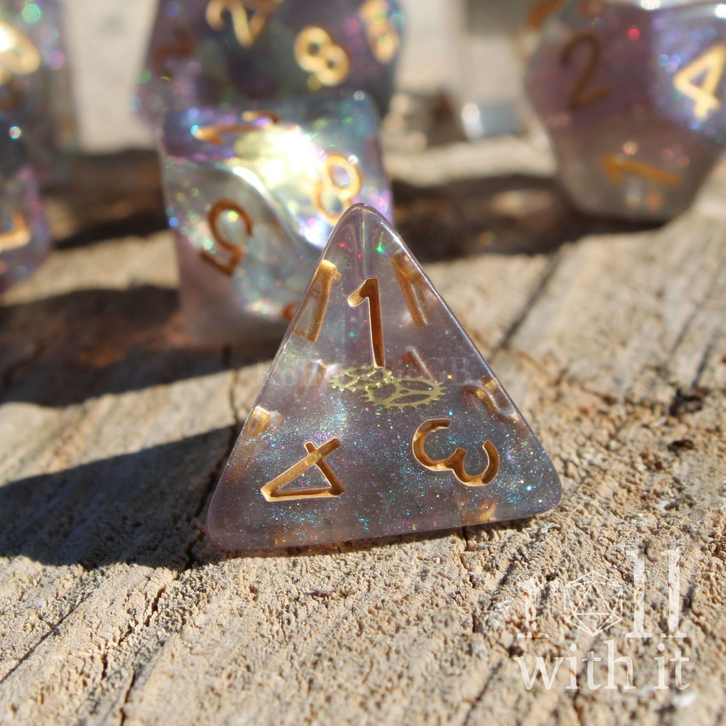Close up of glitter filled dungeons and dragons polyhedral dice with golden cog gear inside on a wooden surface