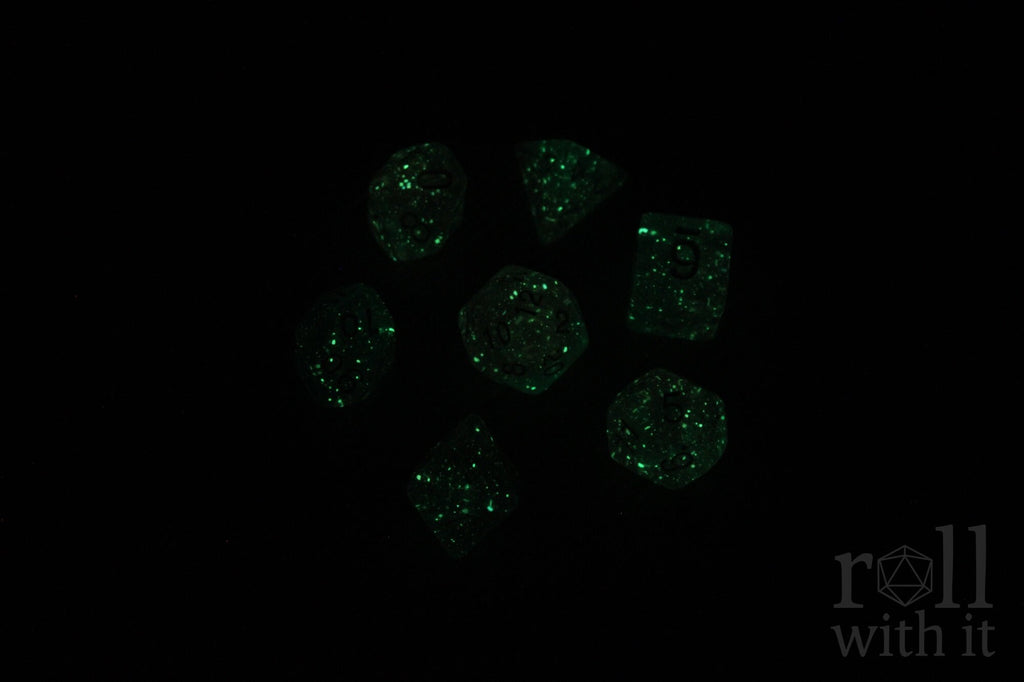 Green glowing dice on a black background