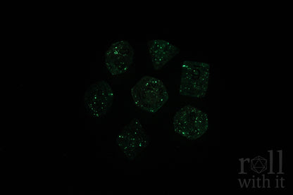 Green glowing dice on a black background