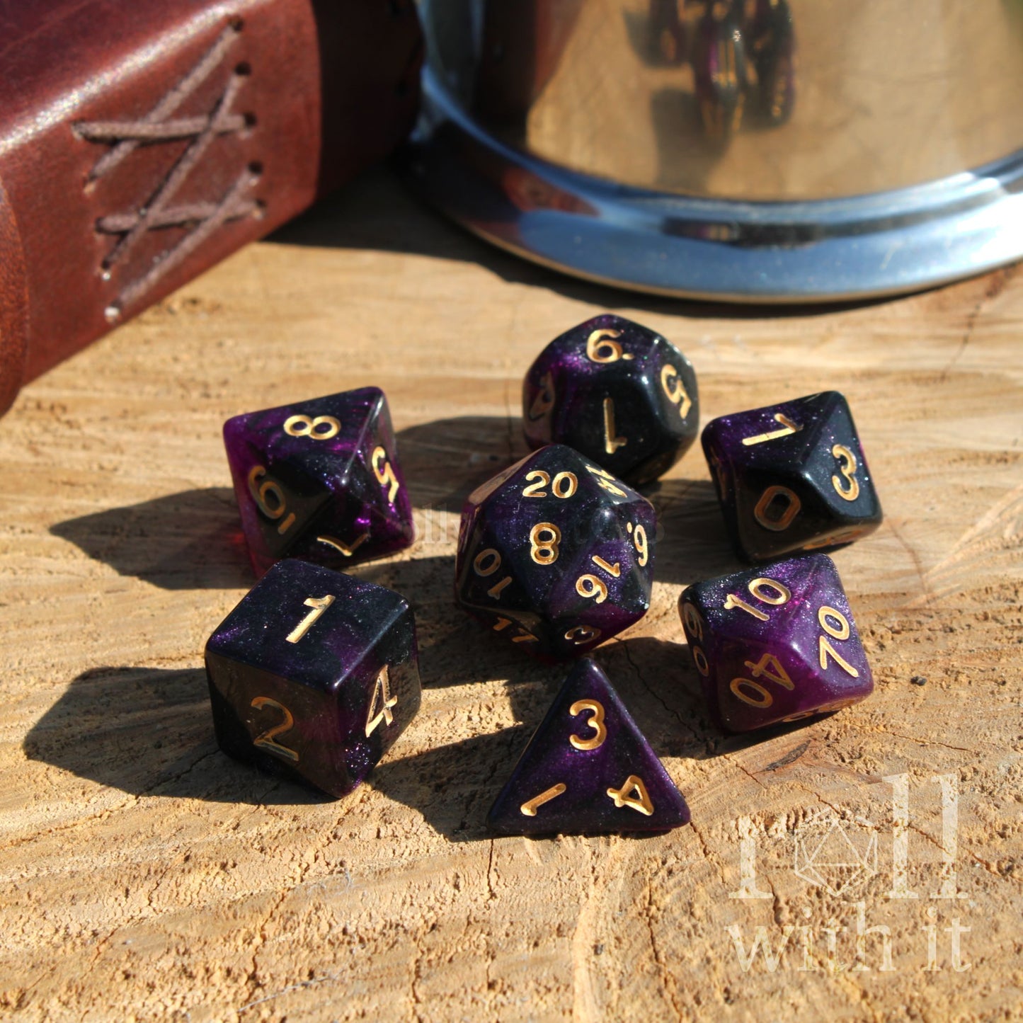 Purple polyhedral dice set on a wooden surface