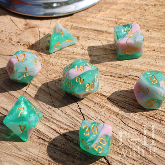 Set of colorful blue green polyhedral dice on a wooden surface