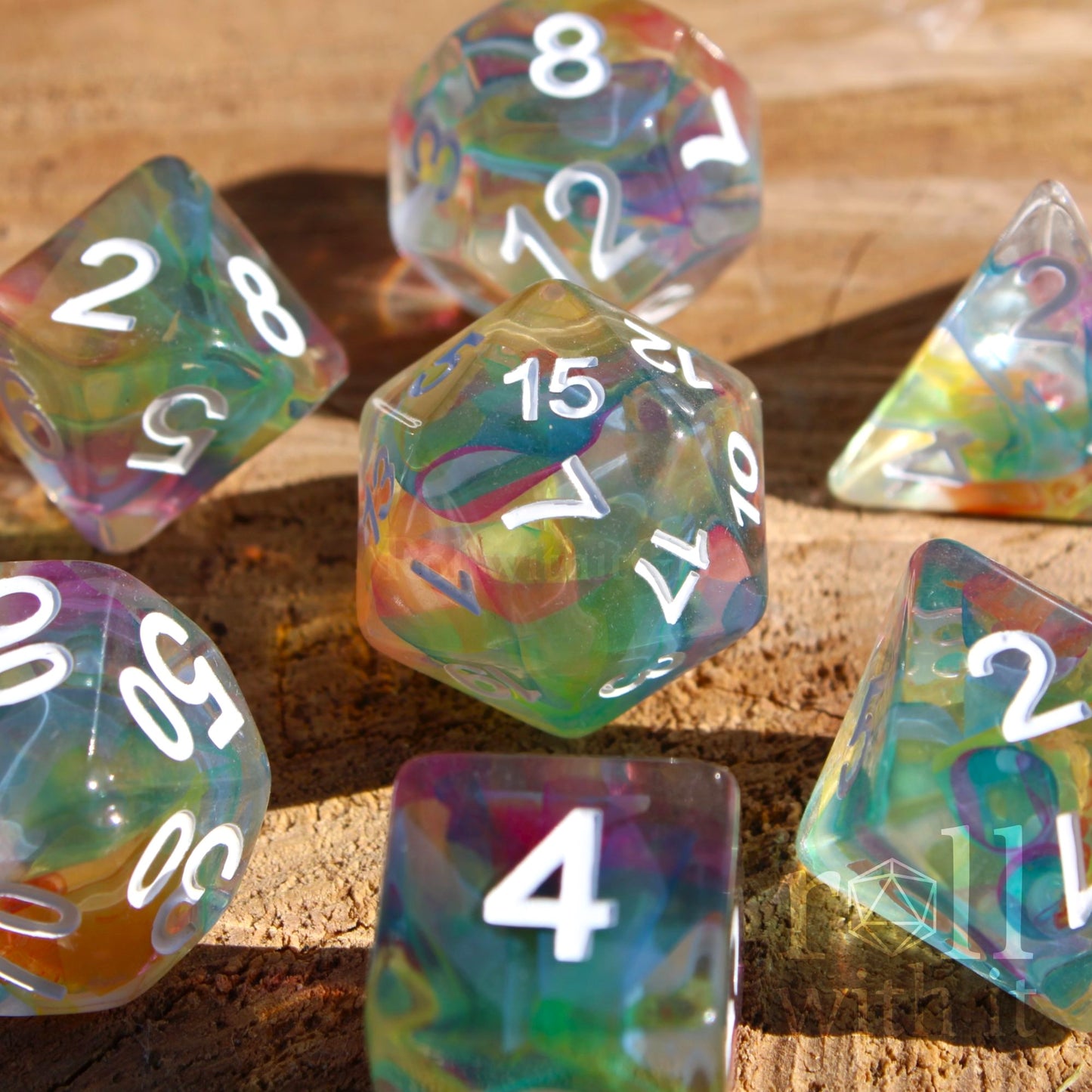 7 swirling rainbow clear dice DND on a wooden surface