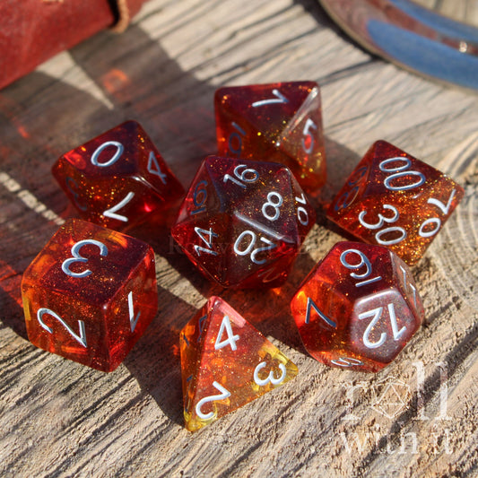 Set of red orange polyhedral dice with white numbers on a wooden surface