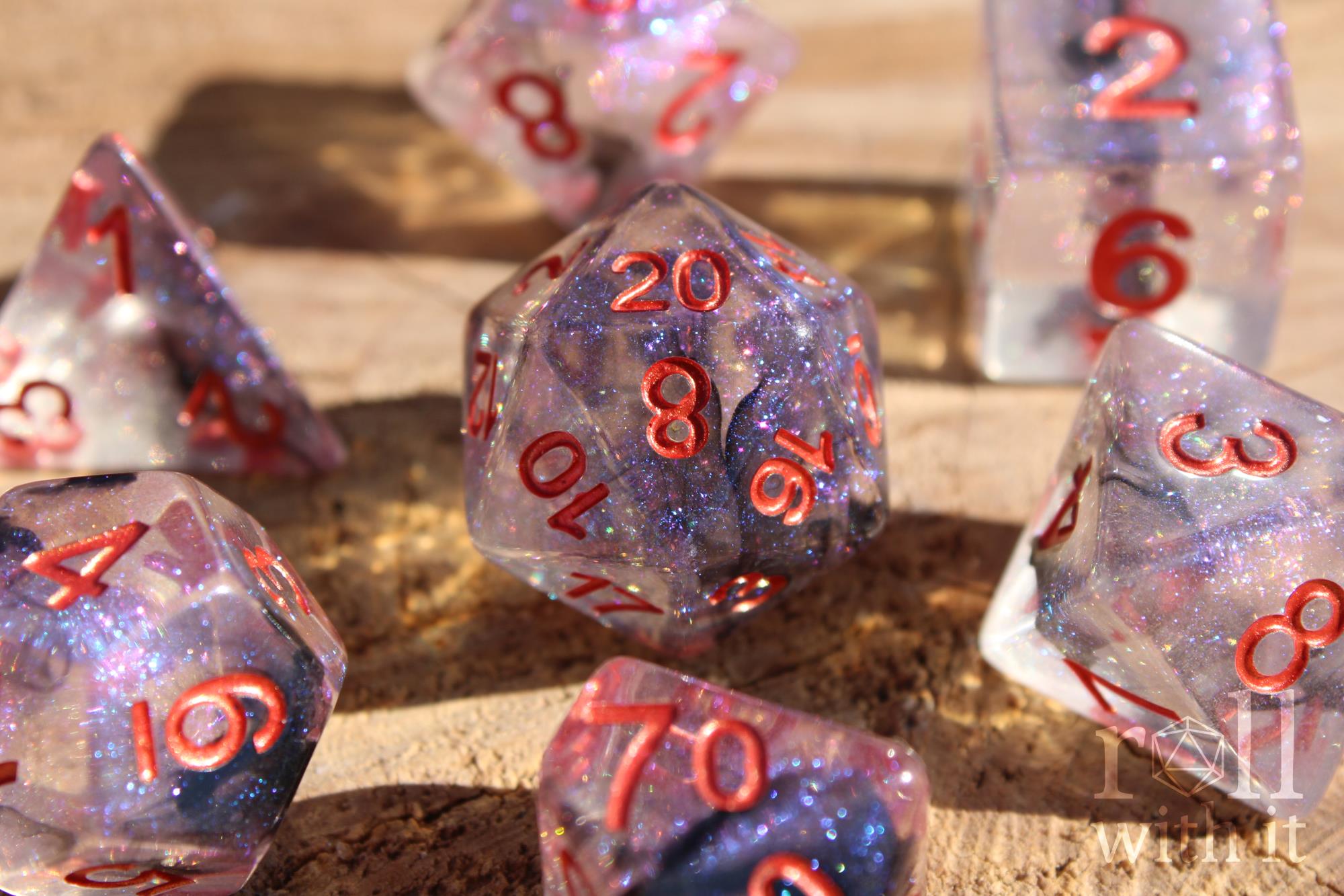 Transparent starry glittery purple and black roleplaying dice with red numbers on a wooden surface