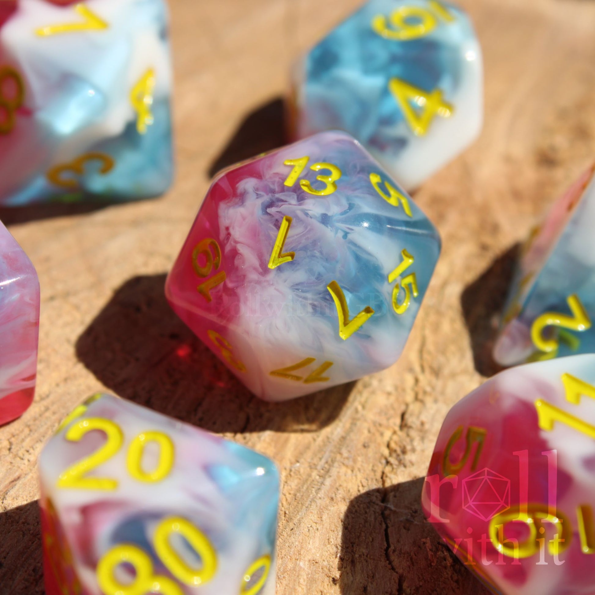 Set of swirling red, blue and white DnD roleplaying polyhedral dice on a wooden base