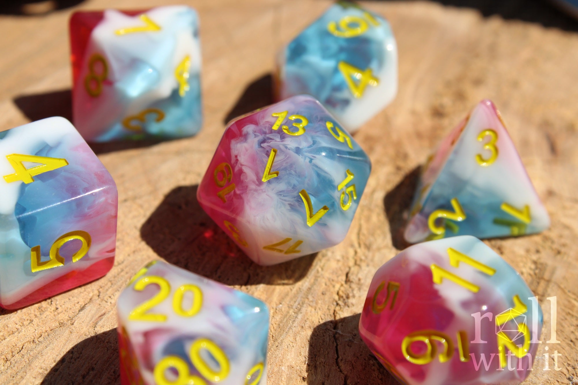 Set of swirling red, blue and white DnD roleplaying polyhedral dice on a wooden base
