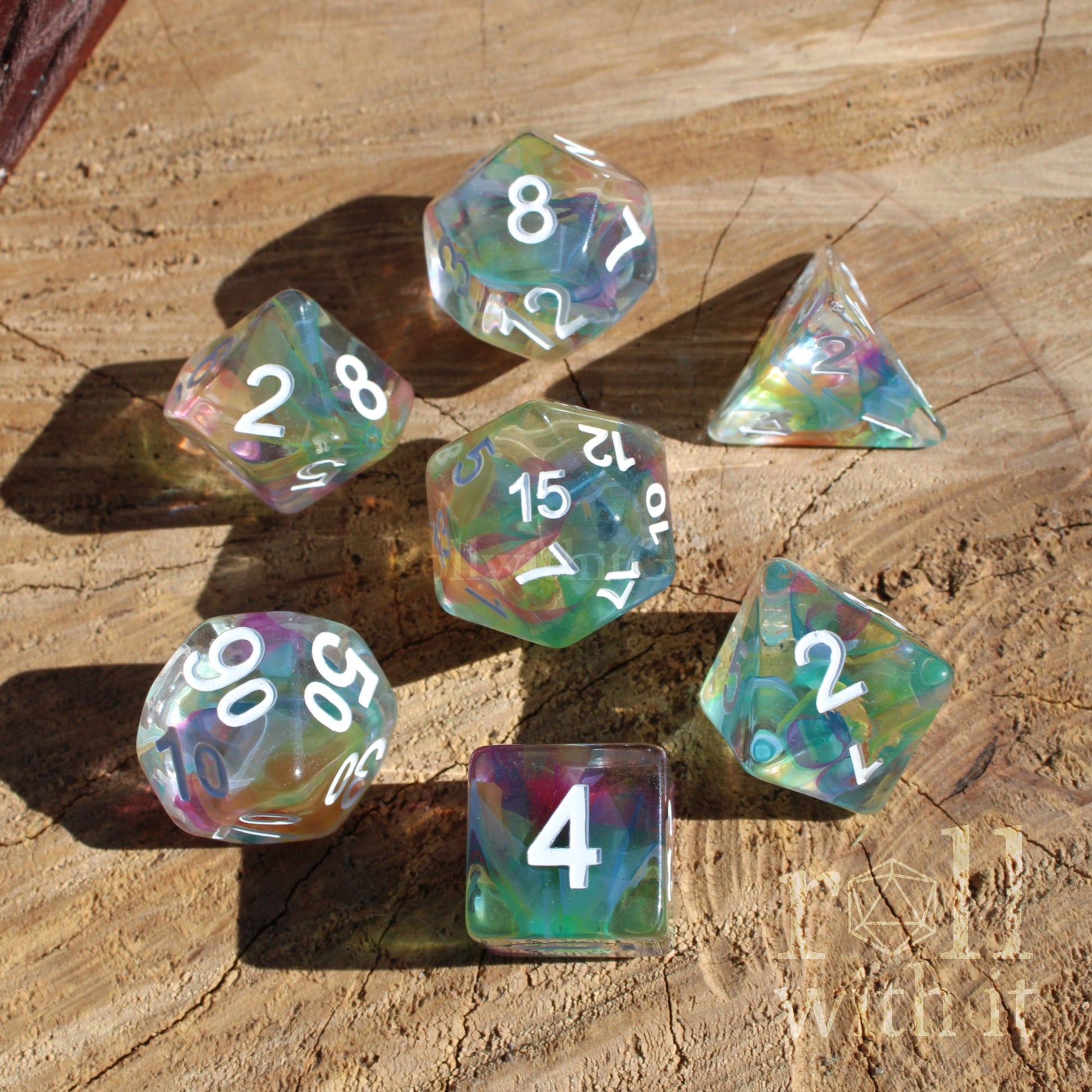 Set of colorful rainbow polyhedral dice on a wooden surface