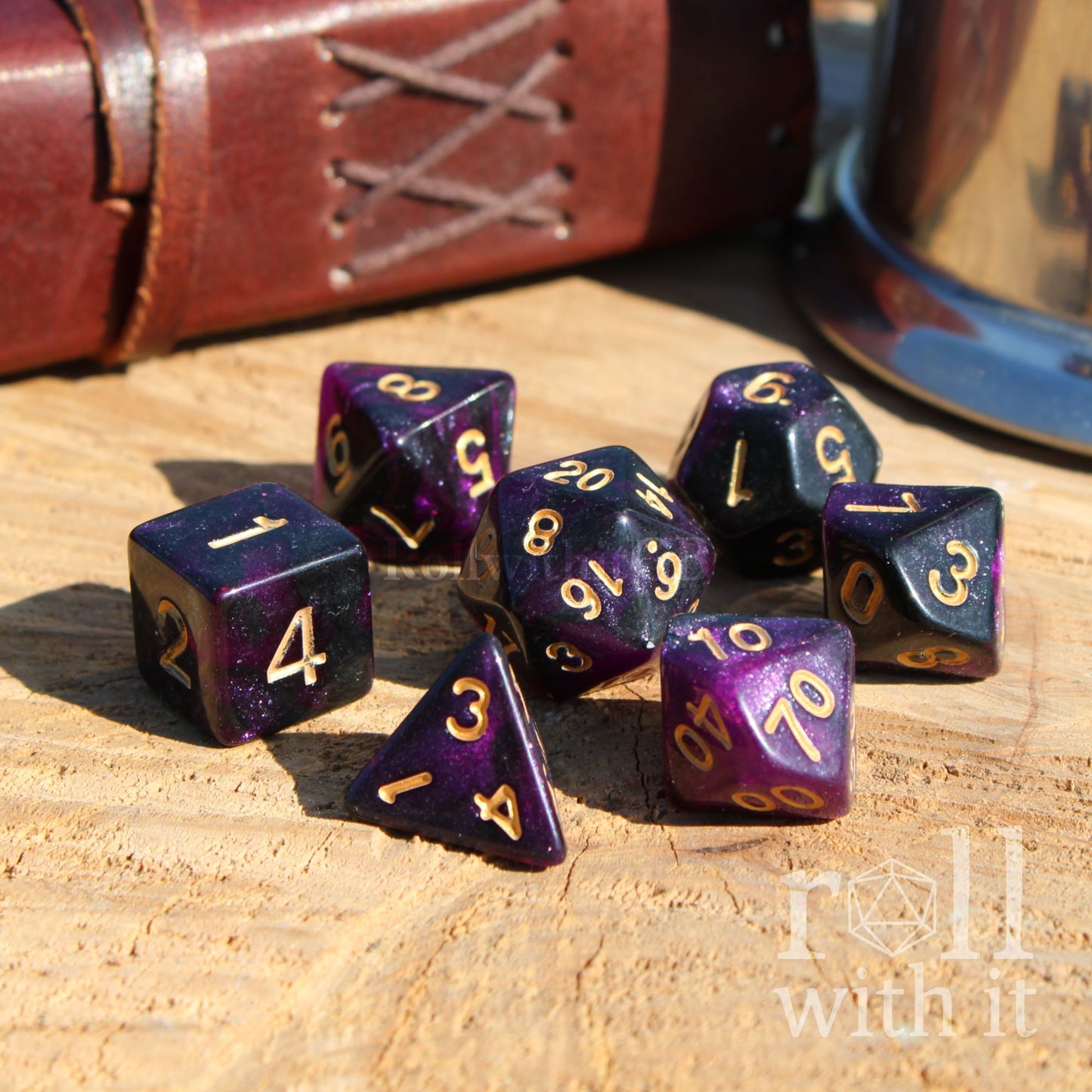 Set of purple star like DnD polyhedral dice set on a wooden surface