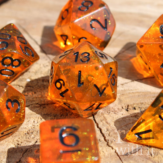 Tangerine Orange 7 polyhedral dice set on a wooden surface