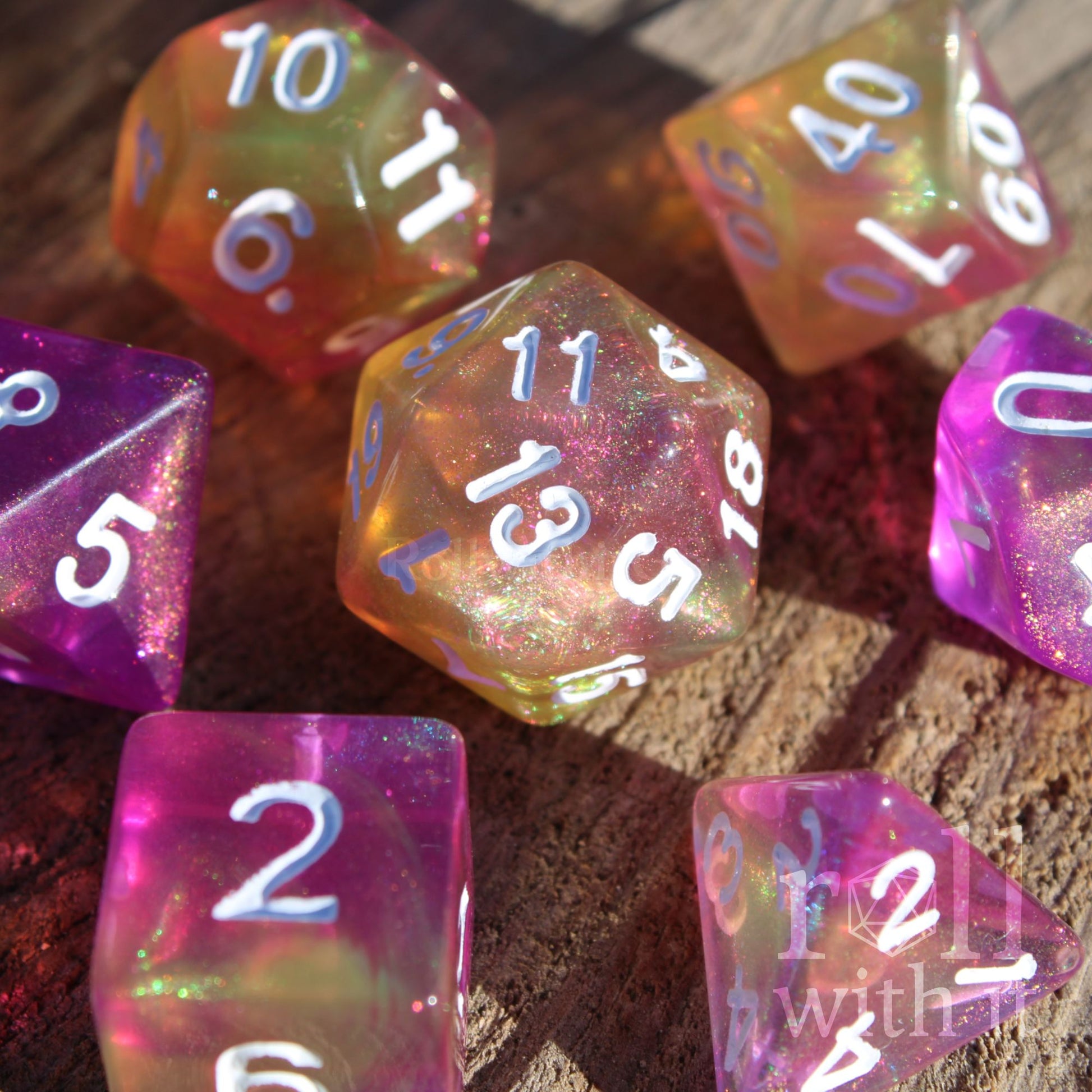 Colorful purple yellow glitter polyhedral dice with white numbers on a wooden surface
