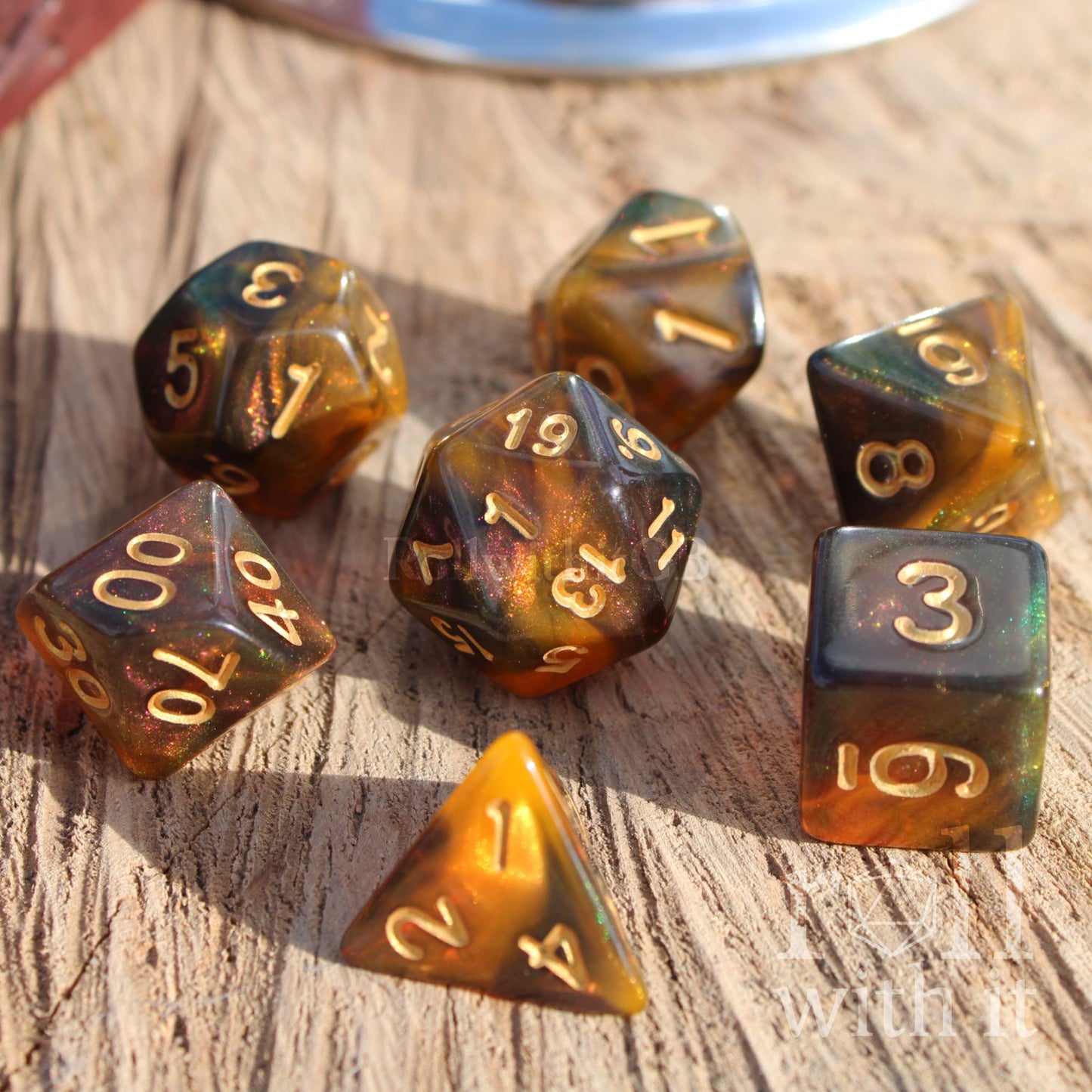 Set of polyhedral dice with brown and black gold honey colors on a wooden surface