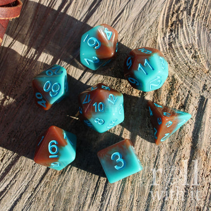 Set of polyhedral dice with blue and brown colors and blue numbers on a wooden surface