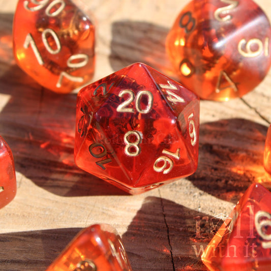 7 red polyhedral copper bronze steampunk dice with gold numbers and metallic cogs and gears inside on a wooden surface