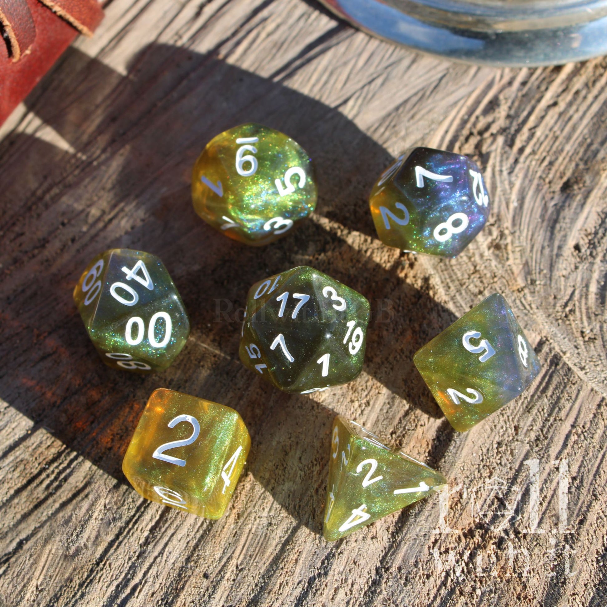 Set of green yellow swampy glitter colorful polyhedral dice on a wooden surface