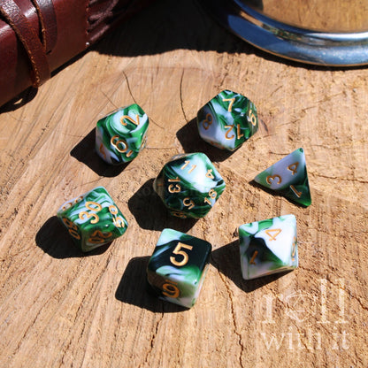 Set of green and white dice with gold numbers on a wooden surface, featuring the brand 'Roll With It'.