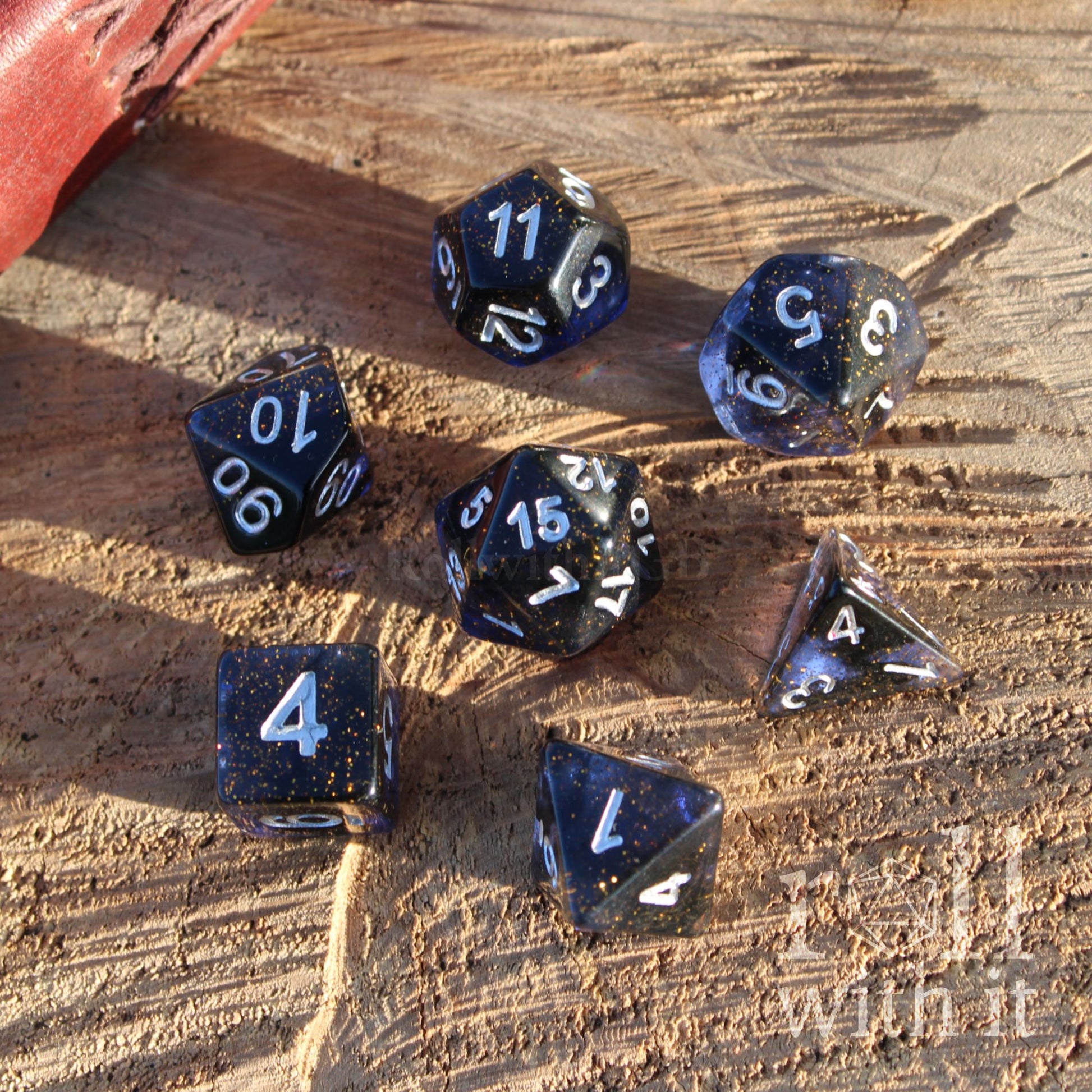 Set of dark space themed dnd polyhedral dice on a wooden surface