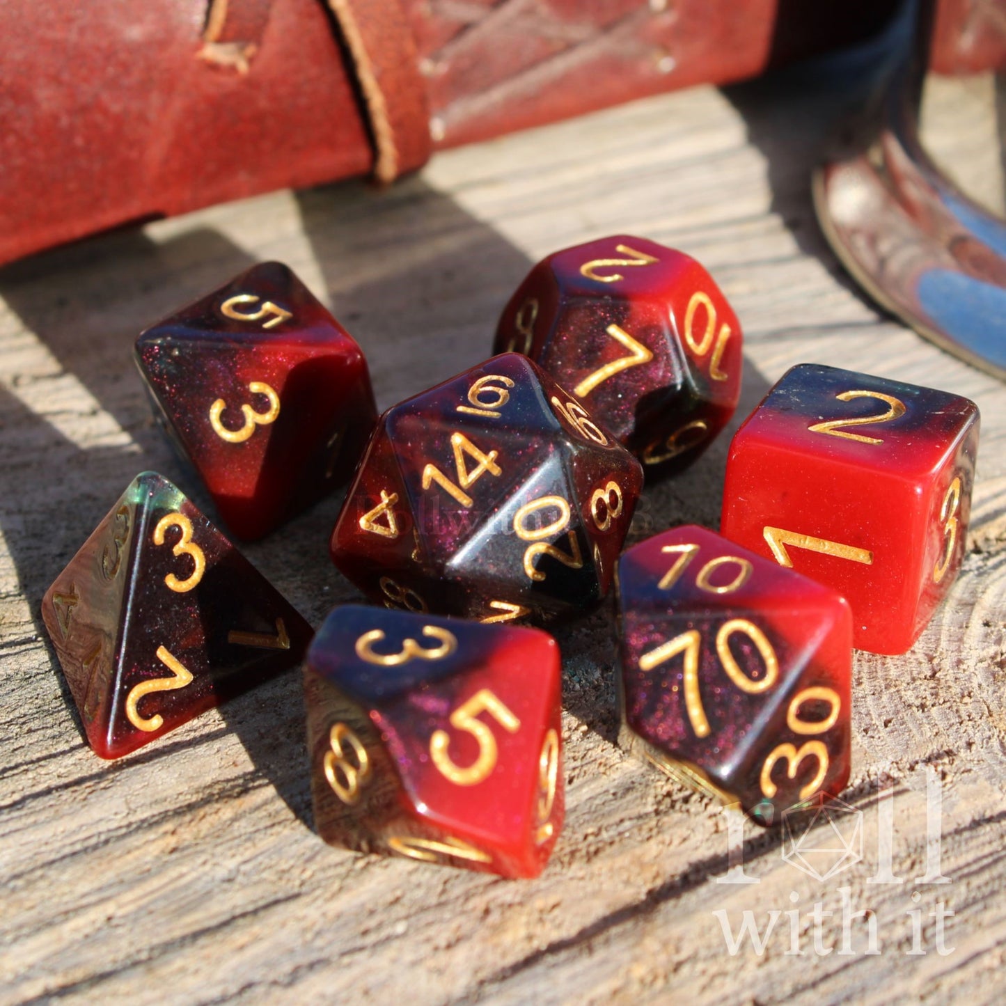 Set of polyhedral dice with red and blue colors split on a wooden surface