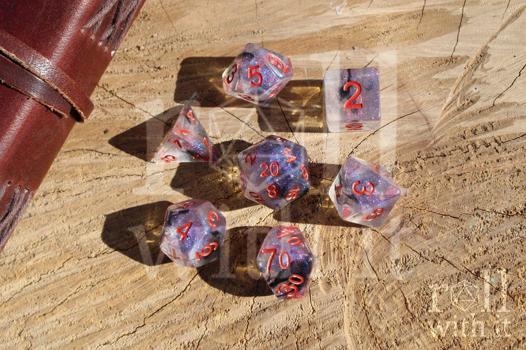 Transparent starry glittery purple and black roleplaying dice with red numbers on a wooden surface